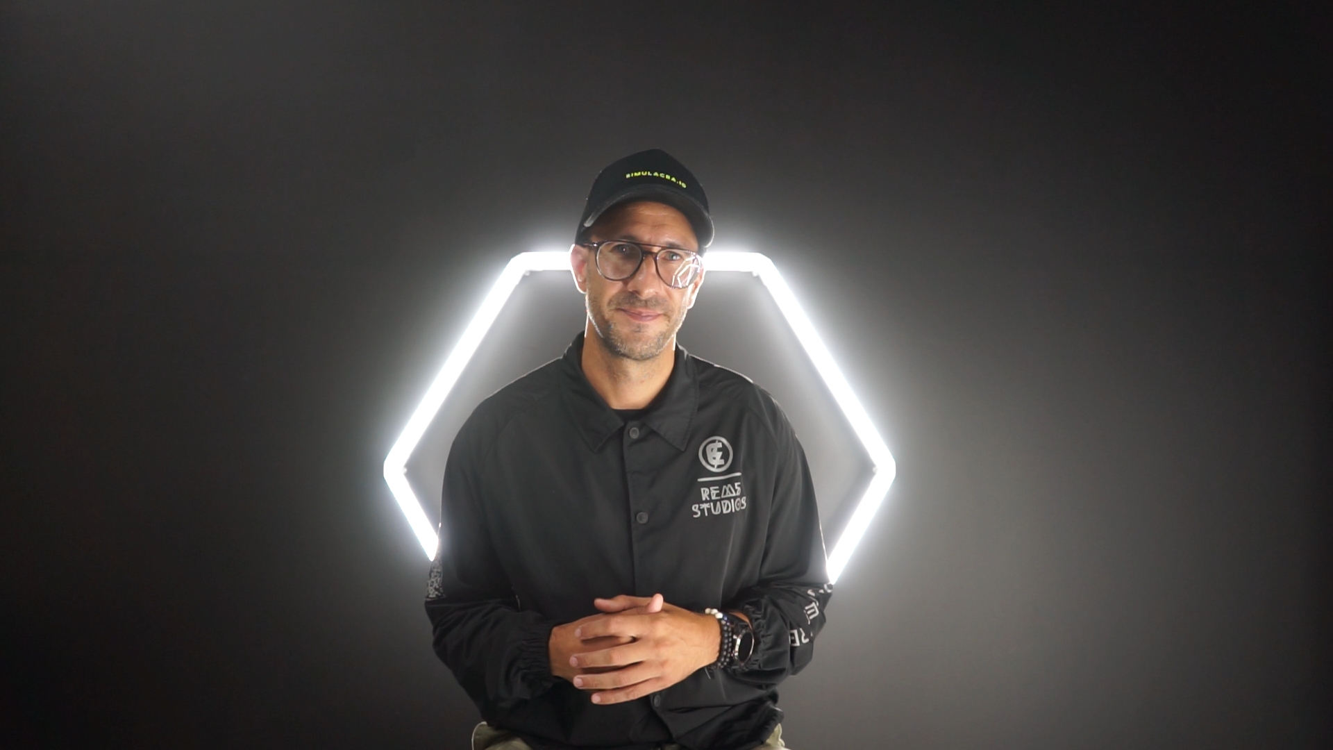amir berenjian of rem5 vr labs standing in front of black background with neon light